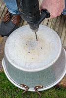 Step 1. Holes are drilled in the base  for drainage. Planting an old aluminium preserving pan in early spring. 