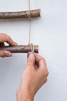 Create a loop with the string for attaching the Hazel sticks