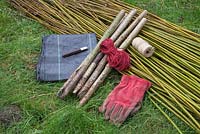 Materials required are Hazel stakes, string, gloves, knife, weed control fabric, Scarlet Willow and Common Osier Willow