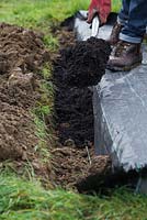Fill the shallow trench with compost