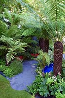 Garden For Crohns Disease. Lush Hardy Exotics planting. Designers: Andrew Fisher Tomlin and Dan Bowyer. Sponsors: Bowel Disease UK. RHS Hampton Court Palace Flower Show 2016