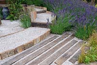 The Lavender Garden. Lavenders along timber and gravel walkway. Designers: Paula Napper, Sara Warren and Donna King. Sponsors: Shropshire Lavender. RHS Hampton Court Palace Flower Show 2016