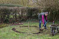 Use a spade to dig out a shallow border 8 inches wide. Mark out three separate entrances for the teepee using three equal length sticks