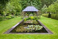 Rectangular pond with relaxing area under gazebo. Sarina Meijer garden.