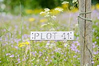 Wooden Allotment Plot Sign on Chicken Wire Fence, May