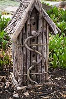 Grey wood rustic birdhouse hotel made of tree branches