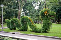 Ho Chi Minh City - Saigon, Vietnam Park feature. Topiary dragons in Cong Vien Van Hoa Park.