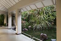 Contemporary building corridor with tropical gardens and pool - Myanmar