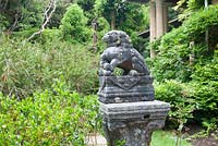 Stone animal statue in the Gardens of Ilnacullin - Garinish Island. Glengarriff, West Cork, Ireland. The Gardens are the result of the creative partnership of Annan Bryce and Harold Peto, architect and garden designer. August