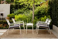 Contemporary white metal garden furniture on compacted gravel - Graduate Gardeners 'Sunken Retreat' Garden - RHS Malvern Spring Show 2016. Designer: Ann Walker