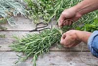 Tying rosemary with string