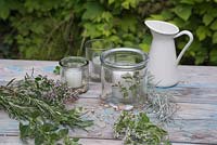 Ingredients needed to make herb decorated candles with Curry Plant, Rosemary, Marjoram and Mint