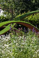 The World Vision Garden. Leucanthemum x superbum 'Snowcap' with floating 'waves' of turf. RHS Hampton Court Flower Show. Designer: John Warland. Sponsor: World Vision. 