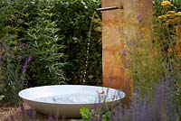 Water feature with Linarea purpurea and Achillea 'Terracotta'. Designer: Martin Royer. Sponsor: Final5.  Final5: Retreat Garden.  