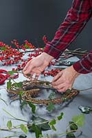 Weaving the Ivy in and out of the wreath frame - creating a berry wreath.