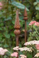 One of Roger Cole-Jones' hand crafted plant supports in a border with Achillea