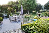 Outdoor dinning area with a view across the garden. Yvan and Gert garden In Belgium.