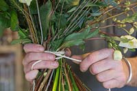 Tying together the bouquet with string