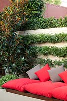 Inner city courtyard with bench seating with grey and red cushions