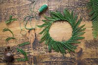 A wreath constructed from green fern fronds