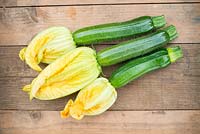 Freshly cut courgettes, 'Defender', with flowers attached.