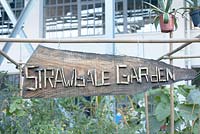 Signboard with wooden letters 'Strawbale Garden'