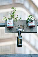 Watering system with bottle and two vintage tins.