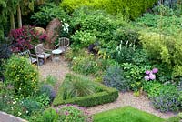 Looking down on herbaceous borders, triangular parterre with Stipa gigantea, timber seating