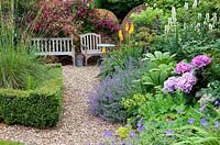 A herbaceous border next to a gravel path leading to