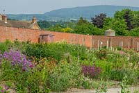 View looking over the walled garden with the shepherds hut to the distant hills.