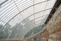 Historic restored greenhouse constructed with postcard sized glass panes.
