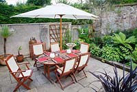Patio dining table and chairs with parasol
