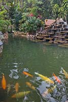 Decorative fountain of stepped flat stones in tropical gardens with pond and goldfish - Lake Atitlan Hotel, Guatemala