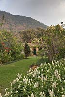 Lawn between borders in garden with views to house and hills beyond - Lake Atitlan Hotel, Guatemala