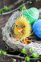 Easter chick made from teasel and cloves, decorative eggs and nest