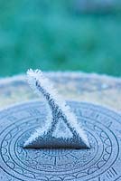 Frost covered garden sundial.