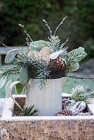 Frosty jug of pine, cones, eucalyptus and hearts