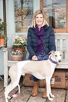 Annie Stanford with three year old whippet Flynn on the platform of the railway carriage
