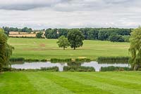 A view of the River Ise and the Northamptonshire countryside from the gardens at Kelmarsh Hall