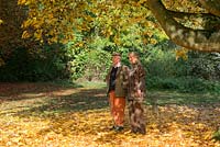 The late Iain Grahame with his wife, Bunny Campione, walking beneath Acer cappadocicum 'Aureum'