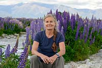 Nicola Stocken, pictured beside River Ahuriri near Omarama in South Island, New Zealand. Lupins self-seed so prolifically as now to be classed an invasive plant.