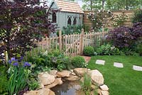 View of pond, through to vegetable garden and Summer House in the Urban Nature Garden at BBC Gardeners World Live 2016