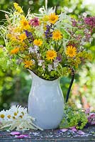 Jug of wildflowers. Leucanthemum, Salvia, Galium verum, yellow ox eye, Silene vulgaris - Bladder campion, Alchemilla, red valerian.