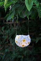 Finished paper lantern with tealight hanging in garden