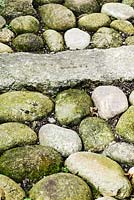 Pebble path with stone 'ribs'.