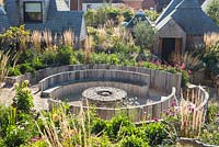 Wide view of Pub garden with raised beds, seating area with fire burner and late summer border. Jo Thompson garden Design, Ticehurst, East Sussex