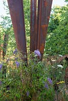 Self-seeded Buddleja davidii next to rusted steel structure - Brownfield Metamorphosis, RHS Hampton Court Palace Flower Show 2017