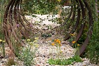 Hampton Court Flower Show, 2017. Brownfield Metamorphosis Garden, des. Martyn Wilson. Pilosella aurantiaca, 'Fox and Cubs' and Achillea 'Moonshine' in gravel garden