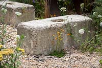 Hampton Court Flower Show, 2017. Brownfield Metamorphosis Garden, des. Martyn Wilson. Concrete seating bench in gravel garden