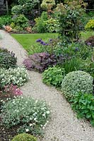 Gravel path bordered with flowerbeds - Jardin de Maggy, Centre-Val de Loire, France